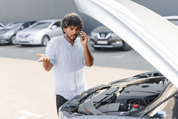 Arjun calling for help with his car hood open